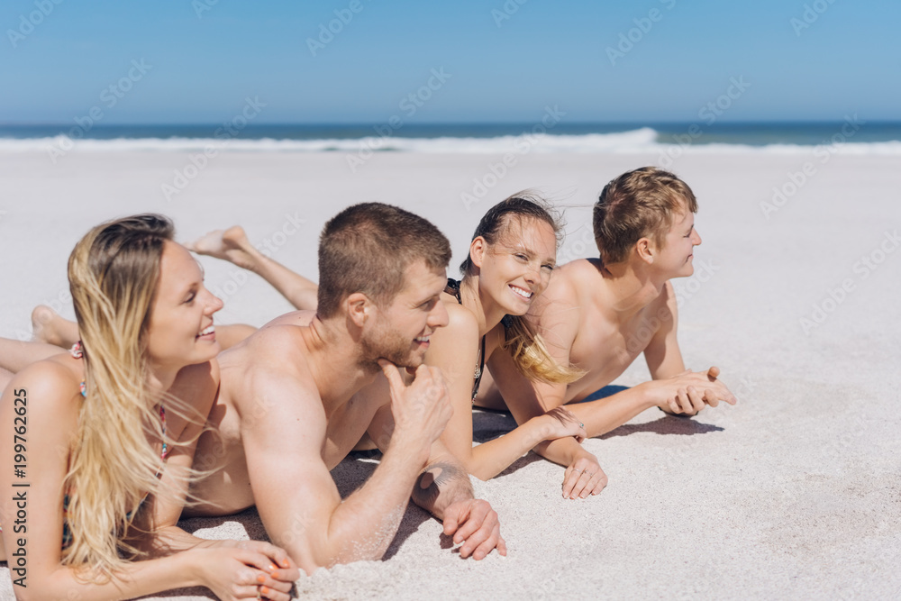 Group of young friends relaxing sunbathing Group of young friends relaxing sunbathing