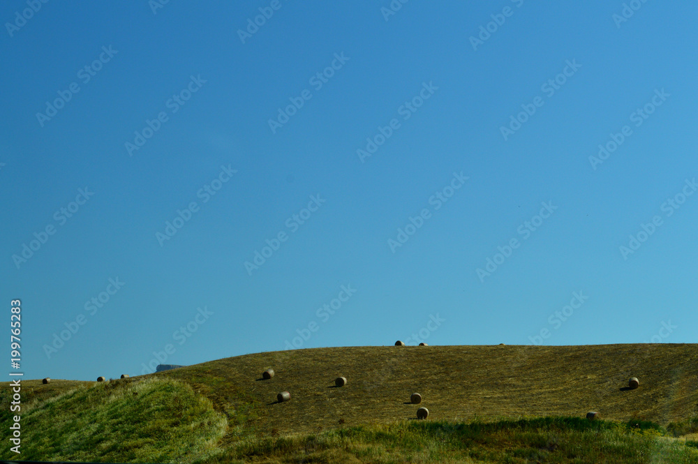 Sicilian Landscape After the Harvest with Hay Bales, Background, Italy
