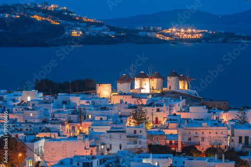Aerial view with traditional windmills on the island Mykonos, The island of the winds, during evening blue hour, Greece