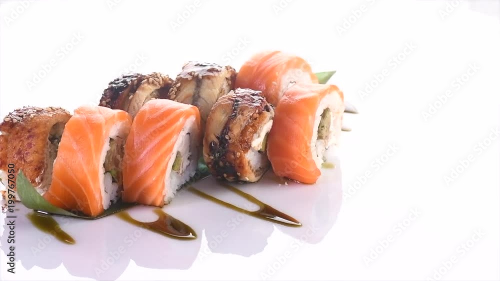 Sushi roll set on white background. Rotated rolls with salmon, tuna, eel, flying fish caviar closeup. Japan restaurant menu. 4K UHD video footage. 3840X2160 Sushi roll set on white background. Rotated rolls with salmon, tuna, eel, flying fish caviar closeup. Japan restaurant menu. 4K UHD video footage. 3840X2160