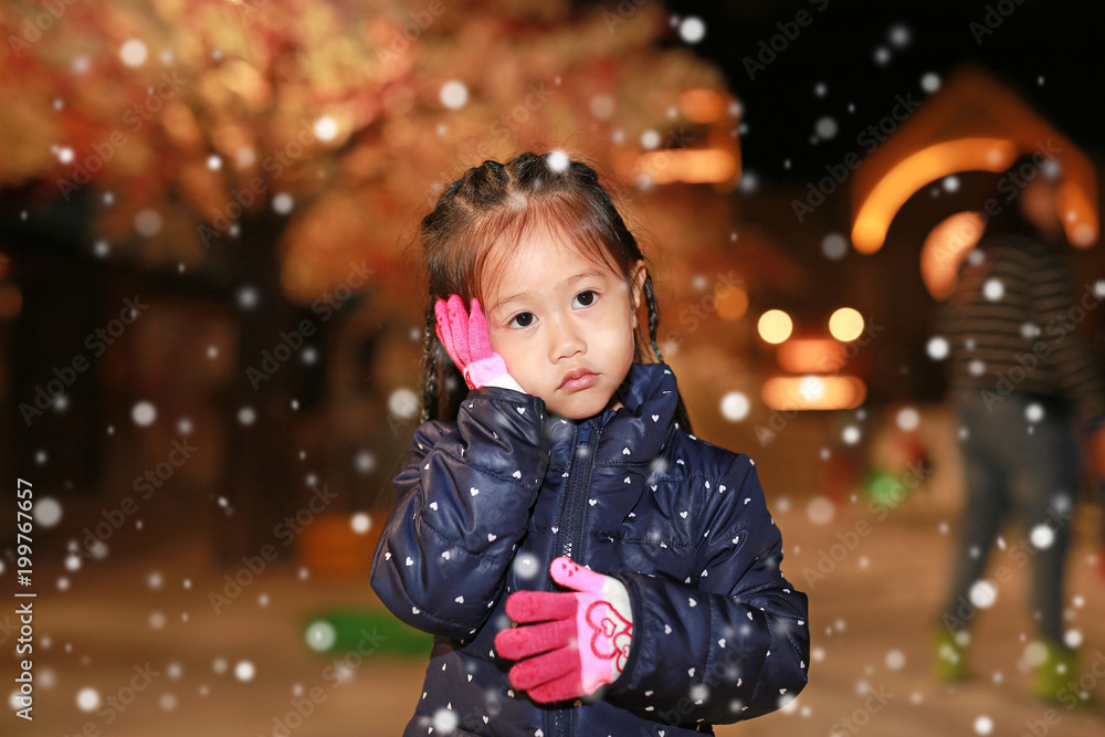 Portrait of little girl touching her cheek in snow, Winter time. Portrait of little girl touching her cheek in snow, Winter time.