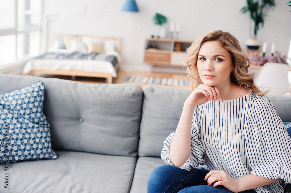 young successful business woman relaxing at home on cozy couch. Modern scandinavian interior, start up, home office concept. young successful business woman relaxing at home on cozy couch. Modern scandinavian interior, start up, home office concept.