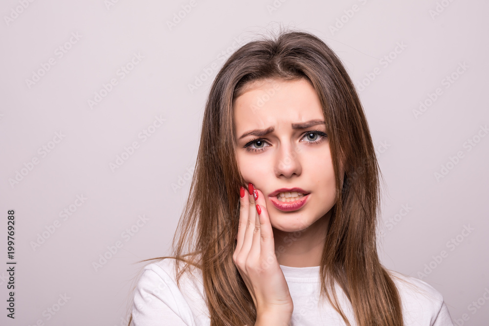 woman suffering from toothache, tooth decay or sensitivity isolated on gray woman suffering from toothache, tooth decay or sensitivity isolated on gray