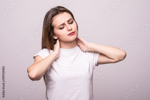 Wallpaper Mural beautiful young woman has a pain in the neck isolated on gray background Torontodigital.ca
