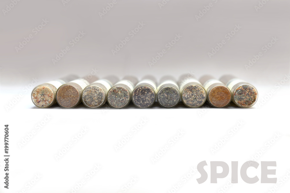 A set of spices in glass flasks with an inscription