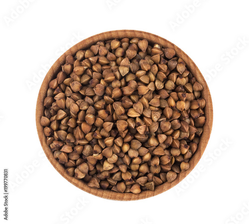 Buckwheat in wooden bowl isolated on white background. Top view
