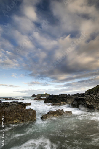 Landscape view of Godrevy lighthouse in Cornwall during lovely sunrise