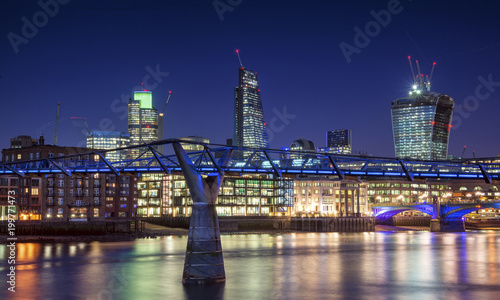 Beautiful London city night skyline landscape with glowing city lights reflected in River Thames