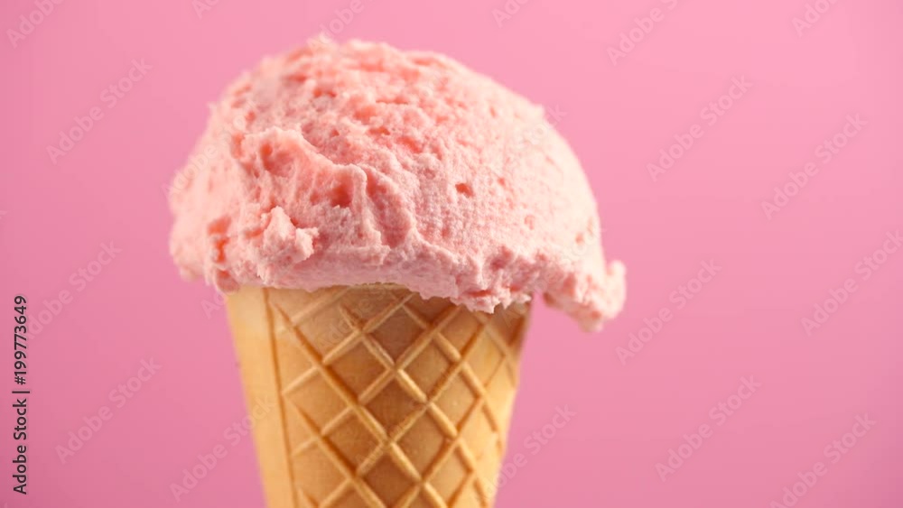Ice cream. Strawberry or raspberry flavor icecream in waffle cone rotated over pink background. Sweet dessert closeup. 4K UHD video footage. 3840X2160 Ice cream. Strawberry or raspberry flavor icecream in waffle cone rotated over pink background. Sweet dessert closeup. 4K UHD video footage. 3840X2160