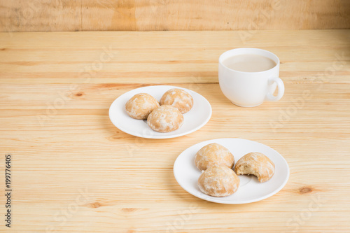 gingerbread on plates and coffee wiht milk on a wooden background. breakfast or snack