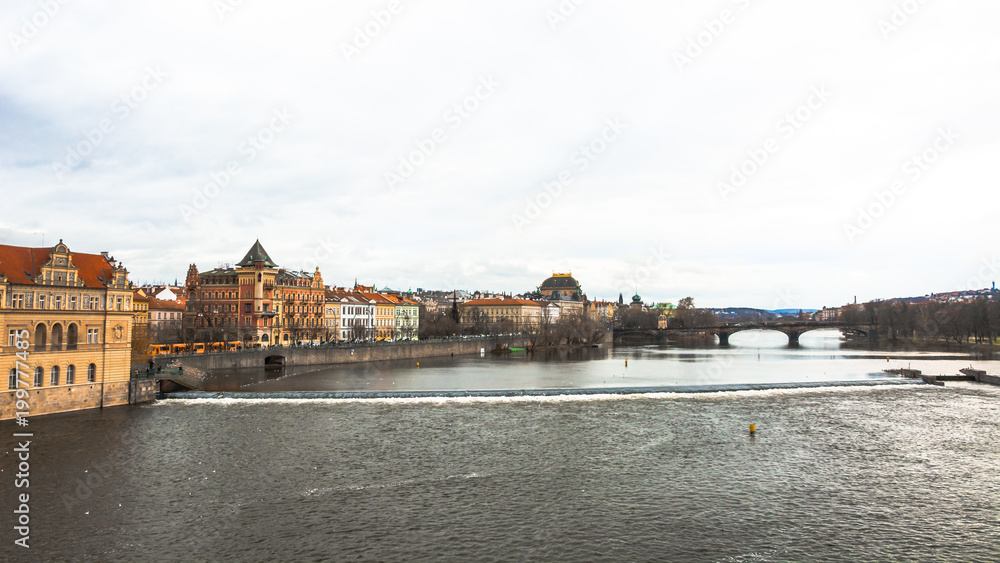 Panorama of the city of Prague. The old part of the city. Beautiful roofs of shingles. Ancient buildings and churches. The stone embankment of the Vistula River.