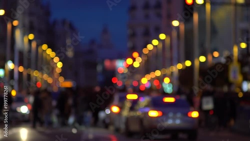 Defocused city pedestrian traffic on a busy street/ Gran Via/ in central Madrid. People crossing the Gran Via street to Plaza Callao in Madrid, Spain.