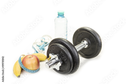 Dumbbell and an apple with a tape measure, isolated on white