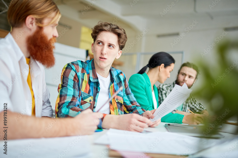 Business people sitting at the table and working with documents and discussing ideas Business people sitting at the table and working with documents and discussing ideas