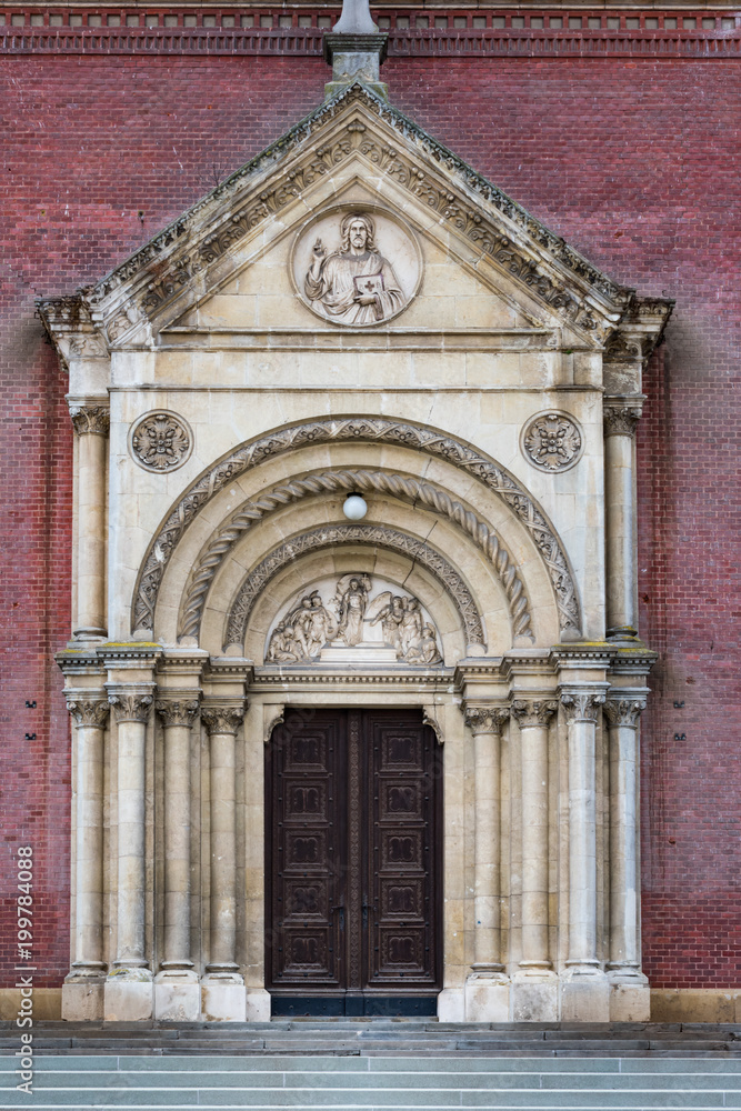 View of the beautiful stone portal with the old, carved, massive, wooden door with cast iron of the Djakovo Cathedral of Basilica of Saint Peter in the city of Djakovo in east Croatia