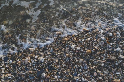 Pebble beach with sea water close up