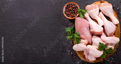 fresh chicken meat on dark board