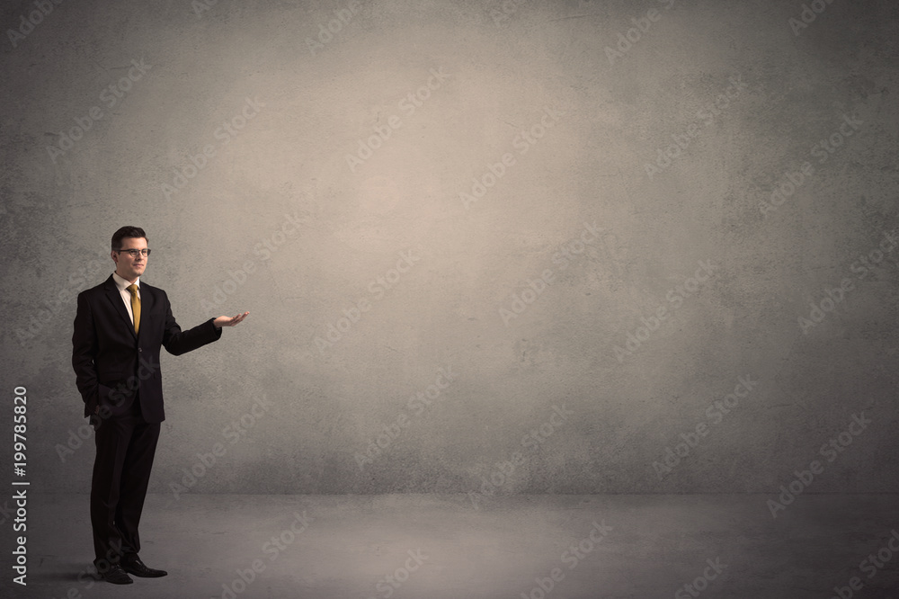 Caucasian businessman standing in front of a grunge, blank wall Caucasian businessman standing in front of a grunge, blank wall