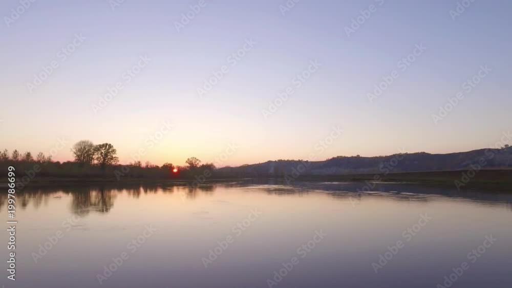 Overgrown broad river sunset sky reflection on water - aerial view Overgrown broad river sunset sky reflection on water - aerial view