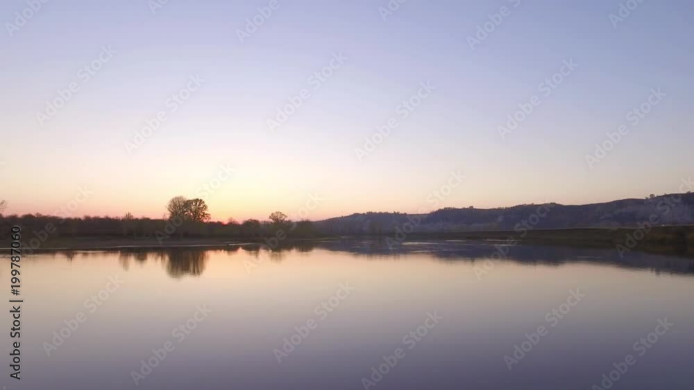 Overgrown broad river sunset sky reflection on water - aerial view Overgrown broad river sunset sky reflection on water - aerial view