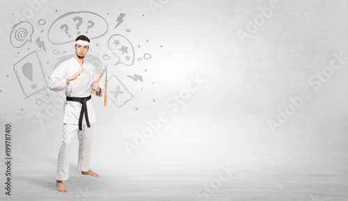 Young kung-fu trainer fighting with doodled symbols concept
