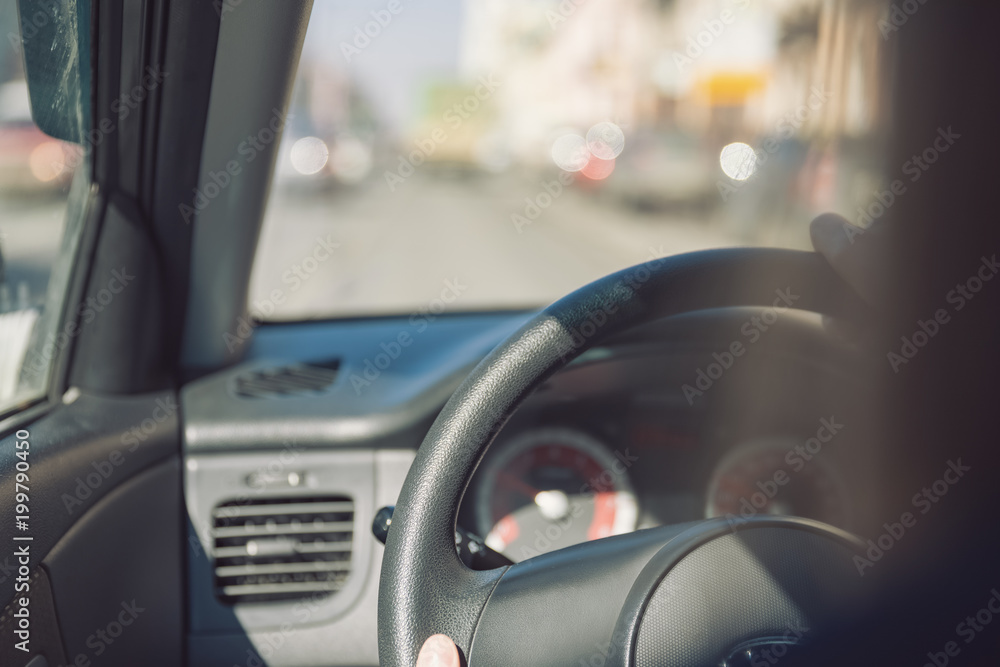 Fototapeta premium Hands of a female driver on steering wheel