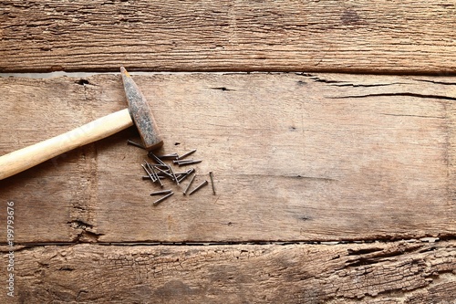 Hammer and nails on wood background