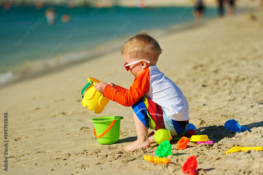 Two year old toddler playing on beach Two year old toddler playing on beach