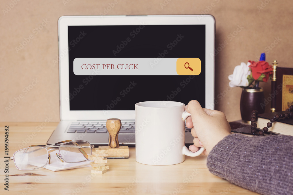muslim woman drinking a coffee and searching cost per click in search bar muslim woman drinking a coffee and searching cost per click in search bar