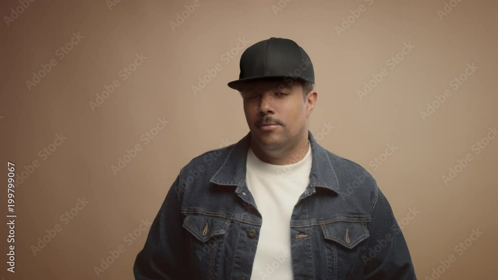 mixed race black man on beige background in studio portrait Colorfull clothes lineal dolly zoom mixed race black man on beige background in studio portrait Colorfull clothes lineal dolly zoom