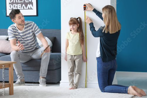 Parents measuring height of...