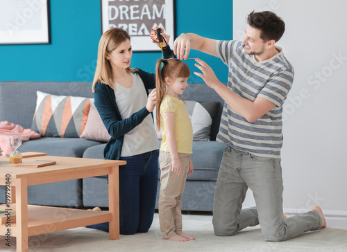 Parents measuring height of...
