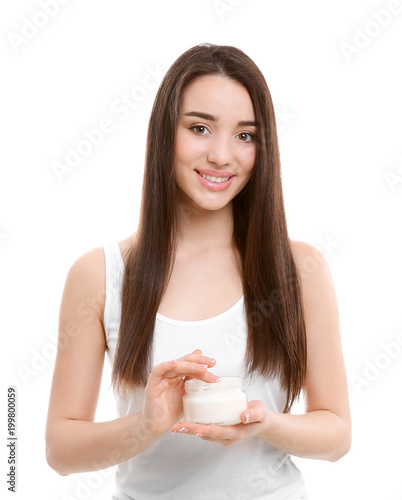Young woman with jar of hair mask on white background