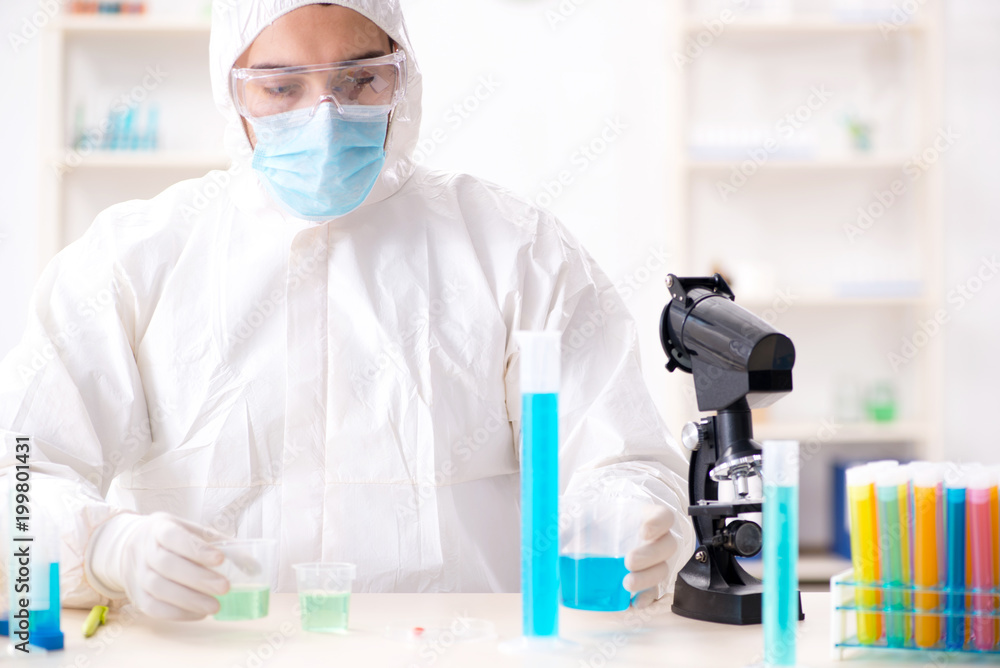 Young chemist student working in lab on chemicals Young chemist student working in lab on chemicals