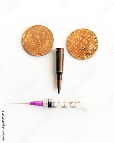 Bitcoins, a syringe, a bullet and a cocaine as a symbol of crimes that can hide crypto-currency (a stylized portrait of a criminal and a terrorist is a concept) photo