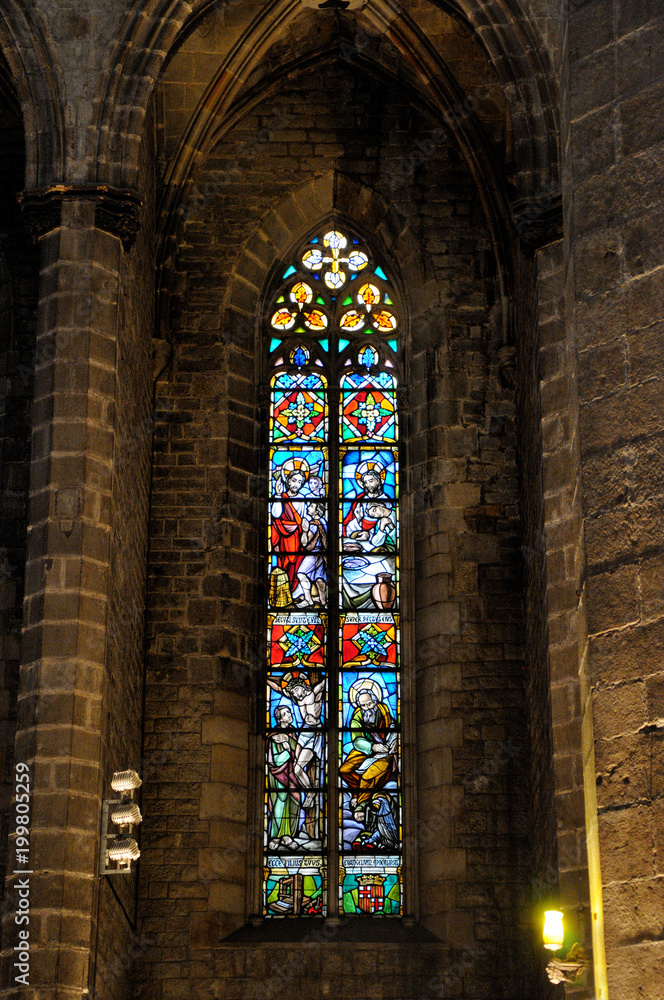 Stained glass window in a cathedral. The colorful window glows in the dark.