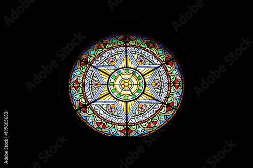 Stained glass window in chapel Santa Cova. Catalonia, Spain.