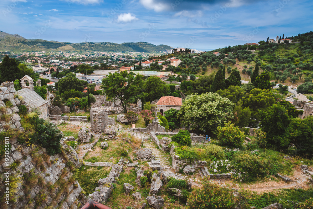 Montenegro landscape with cloudy mountains and ancient stone ruines of Old Bar town. Stari Bar - ruined medieval city on Adriatic coast, Unesco World Heritage Site.