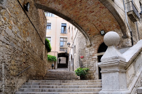 The old city of Girona. Pujada de Sant Domenec stairs and Arch of the Agullana Palace, Catalonia, Spain. photo