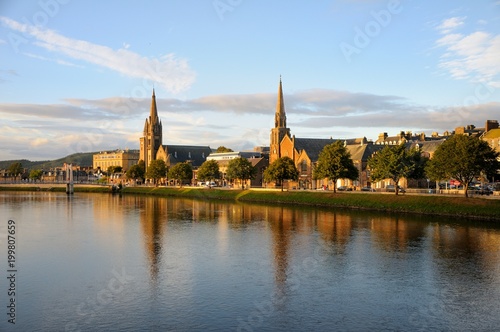 Beautiful Inverness evening cityscape with river view. Two churches are reflected in the water. Inverness, Scotland.