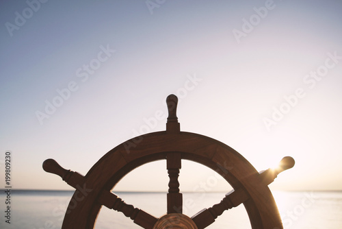 Ship rudder with sea on background.