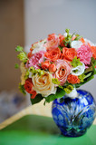 Bouquet of a bride in a blue vase. Beautiful colorful wedding bouquet. Black and white.
