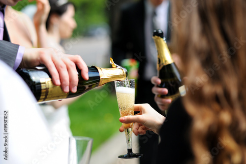 Guests at the wedding pour champagne