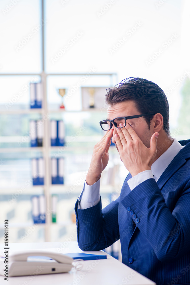 Young handsome businessman employee working in office at desk Young handsome businessman employee working in office at desk