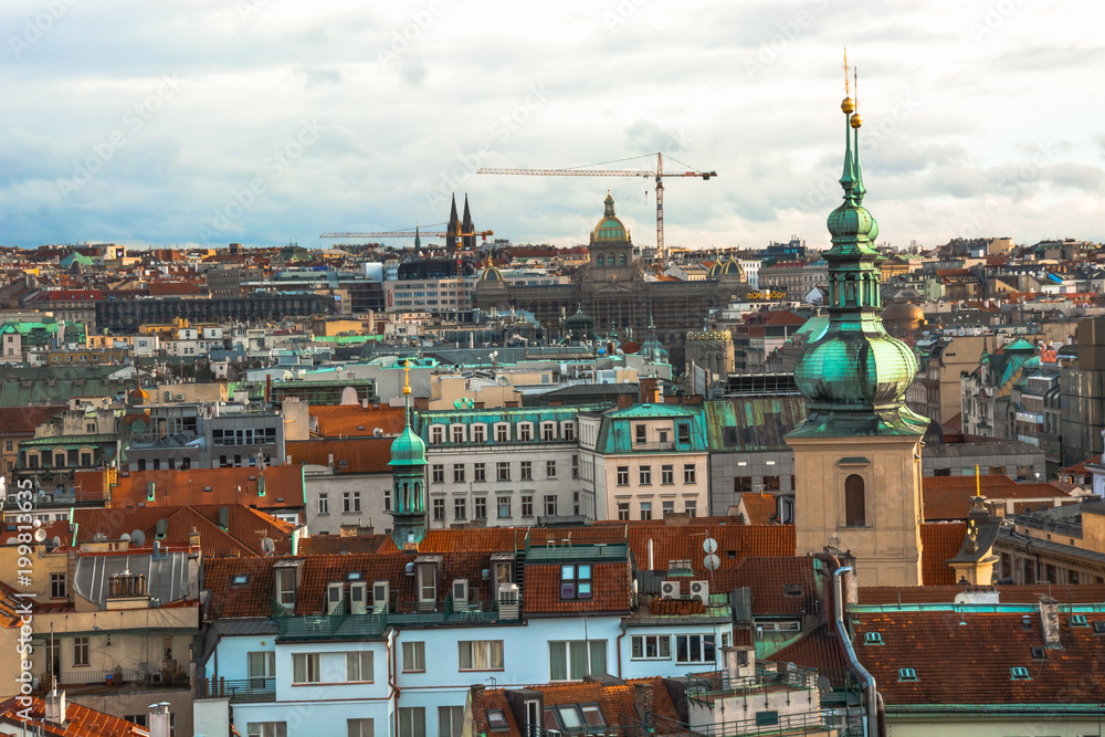 Fototapeta premium Panorama of the city of Prague. The old part of the city. Beautiful roofs of shingles. Ancient buildings and churches.