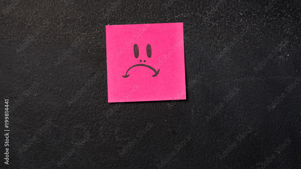Sticky note with sad face icon on the blackboard Stock Photo | Adobe Stock