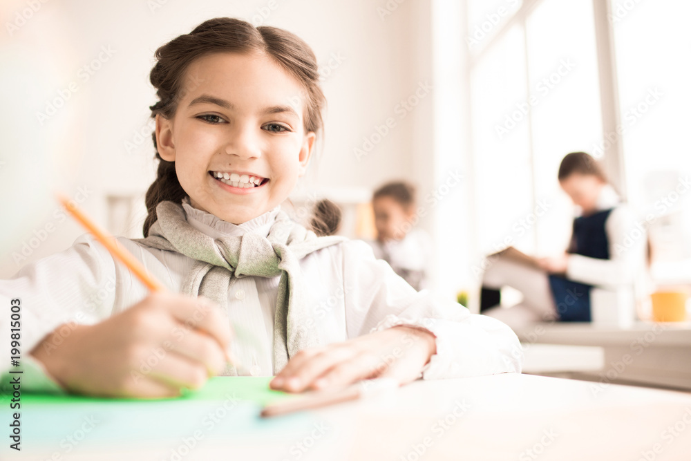 Portrait of smiling girl studying at the table at lesson Portrait of smiling girl studying at the table at lesson