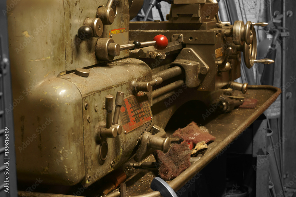 Industrial lathe in a factory workshop with selective color