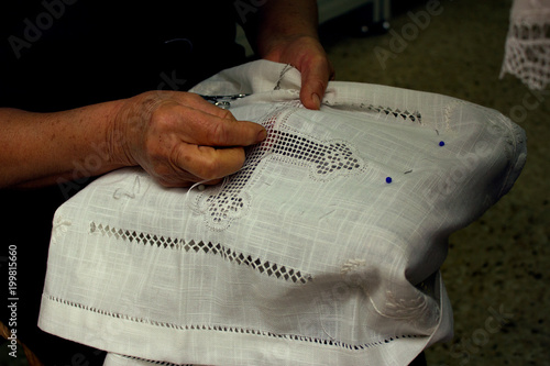 A close up view of an old woman's hands, embroidering Lefkara Lace or 'Lefkaritika' a traditional handmade lace, in Pano Lefkara, Cyprus
