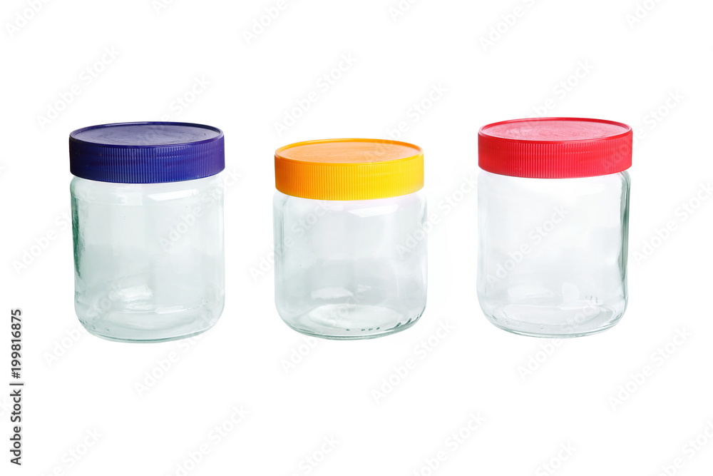 Three empty glass jars isolated on white background. Jars with red blue yellow plastic covers. Three empty glass jars isolated on white background. Jars with red blue yellow plastic covers.